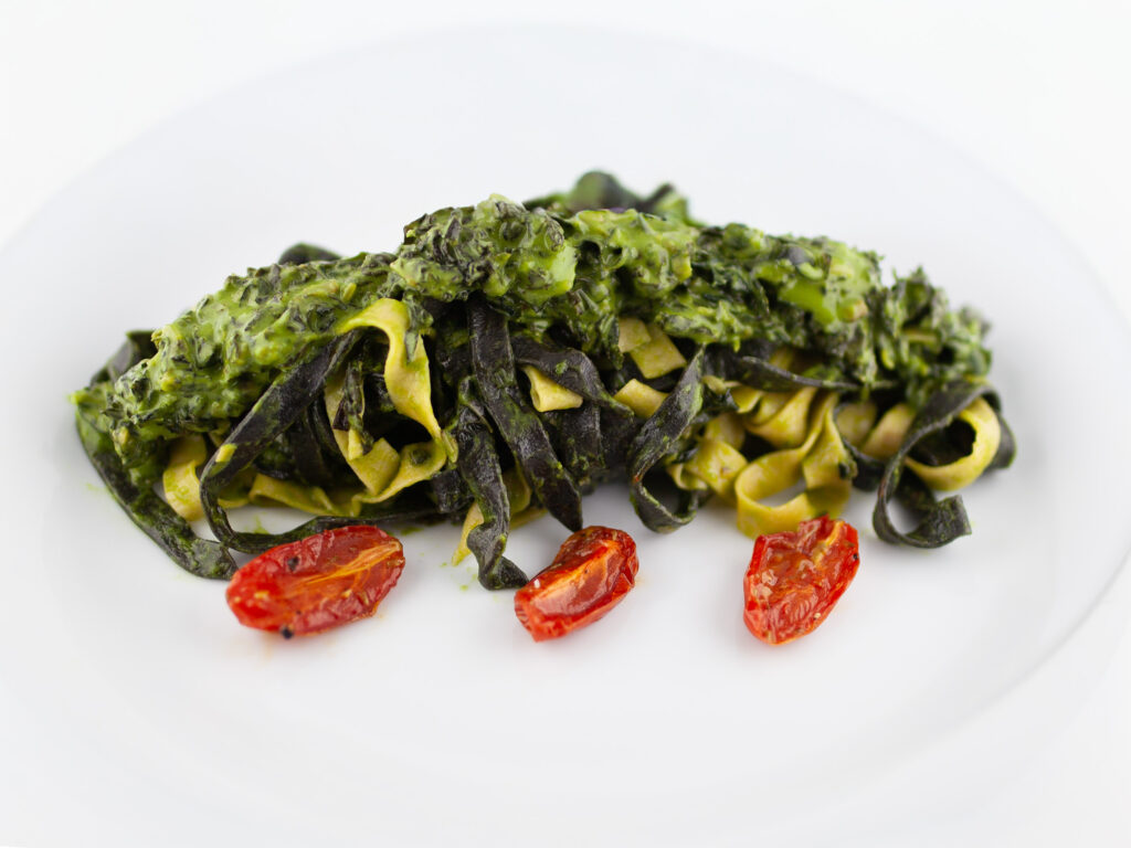 Fresh tagliatelle with black cabbage and confit tomatoes