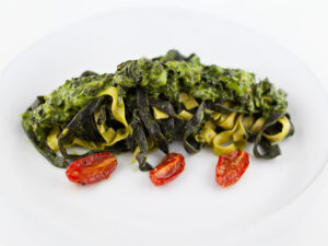 Fresh tagliatelle with black cabbage and confit tomatoes
