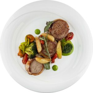 Pork fillet wrapped in lardo with broccoli and potatoes