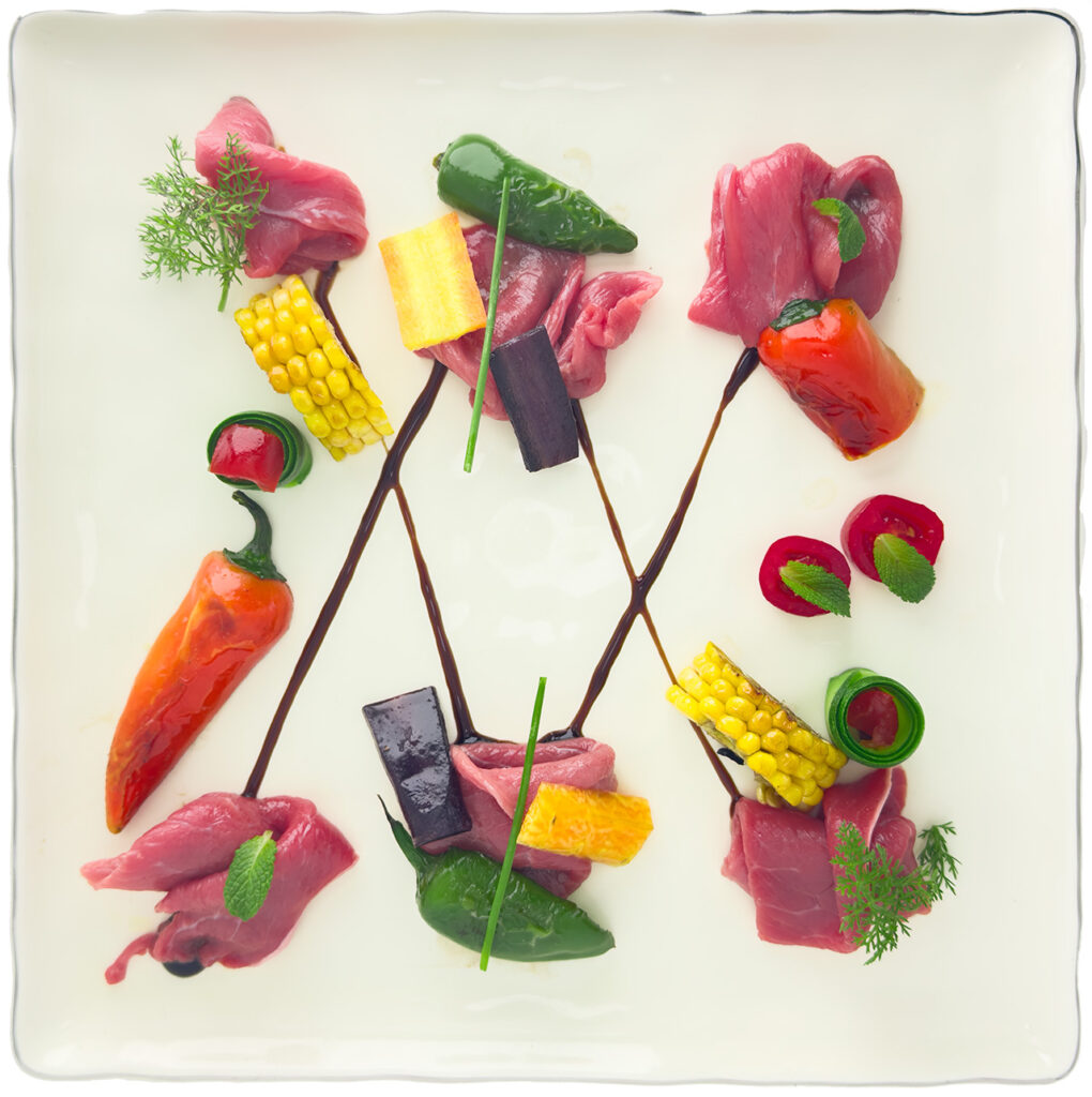 Beef carpaccio neatly arranged on a plate