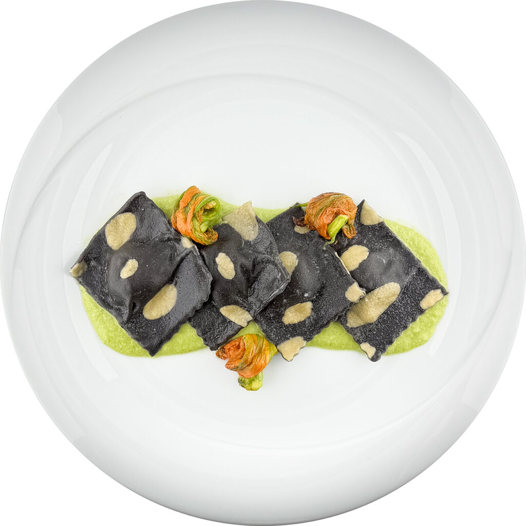 Black-ink raviolo stuffed with salted cod and white wine sauce